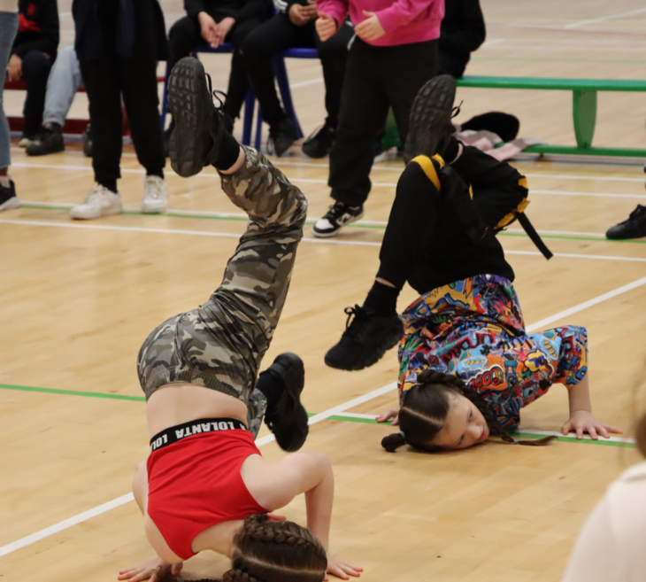 Children dancing in a sports hall